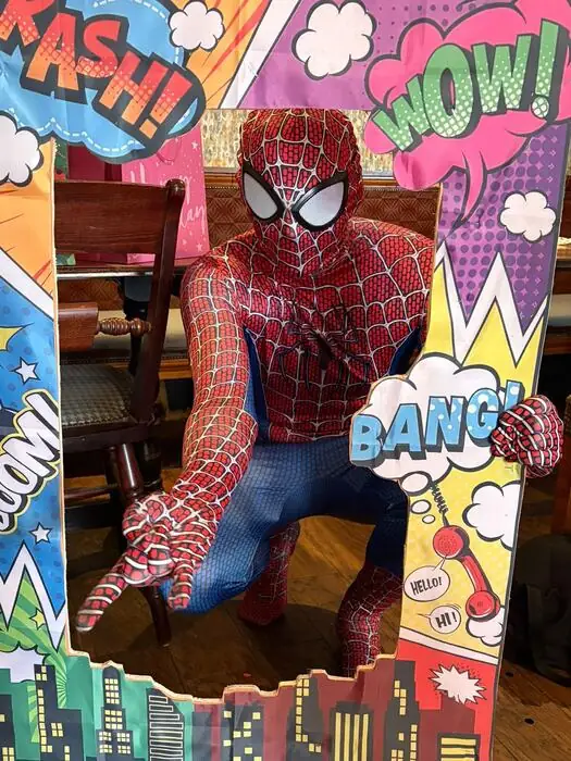 Spider-Man posing in a comic-book style photo booth cutout